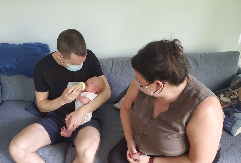 Nadine showing a new dad how to bottle feed